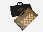 The folding chess board beside its branded black Handle carry bag