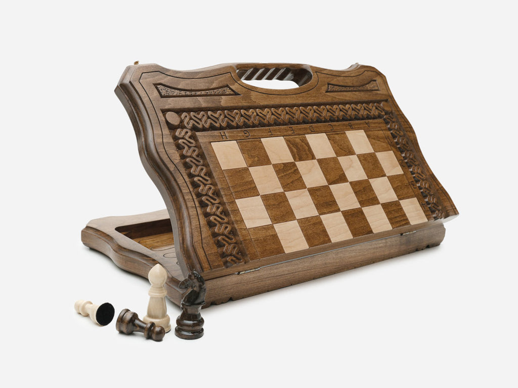 Top-down view of the opened carved folding chess set with beech and walnut pieces, acanthus borders and side carry handles