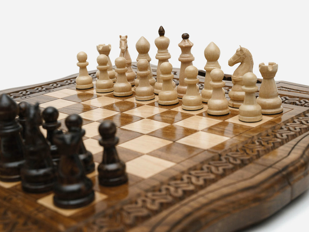 The folding chess set partly closed, showing its briefcase form