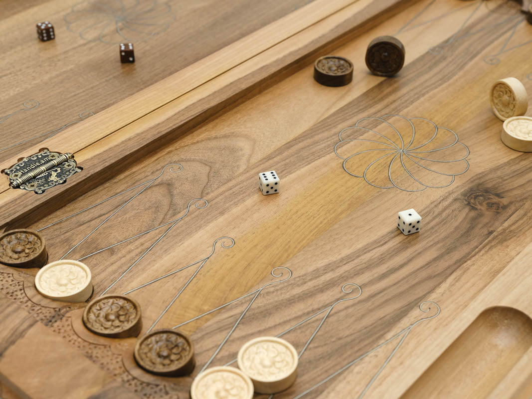 Carved bird motif at the corner of the board