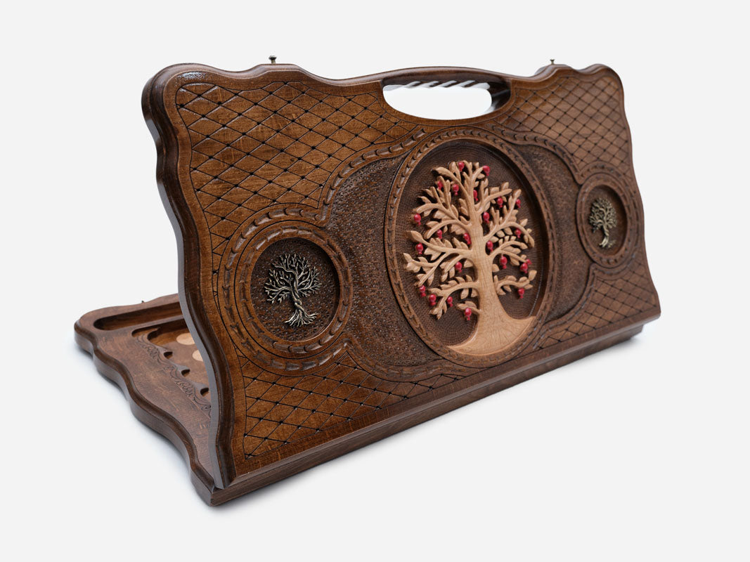 Carved beechwood backgammon board with a bronze tree of life and a carry handle, propped open