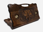 Carved beechwood backgammon board with an octagonal bronze medallion and a carry handle, propped open