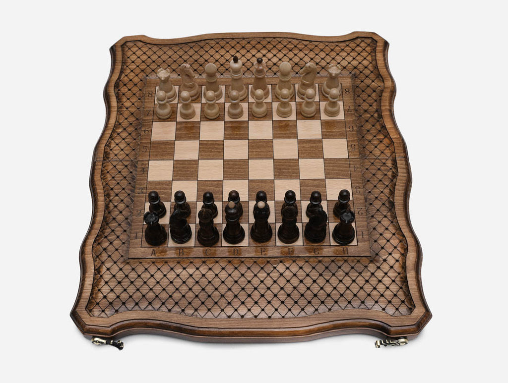 Handle chess board open flat with all 32 wooden pieces set up for a new game, top view