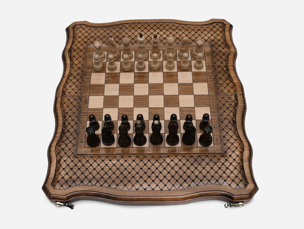 Handle chess board open flat with all 32 wooden pieces set up for a new game, top view