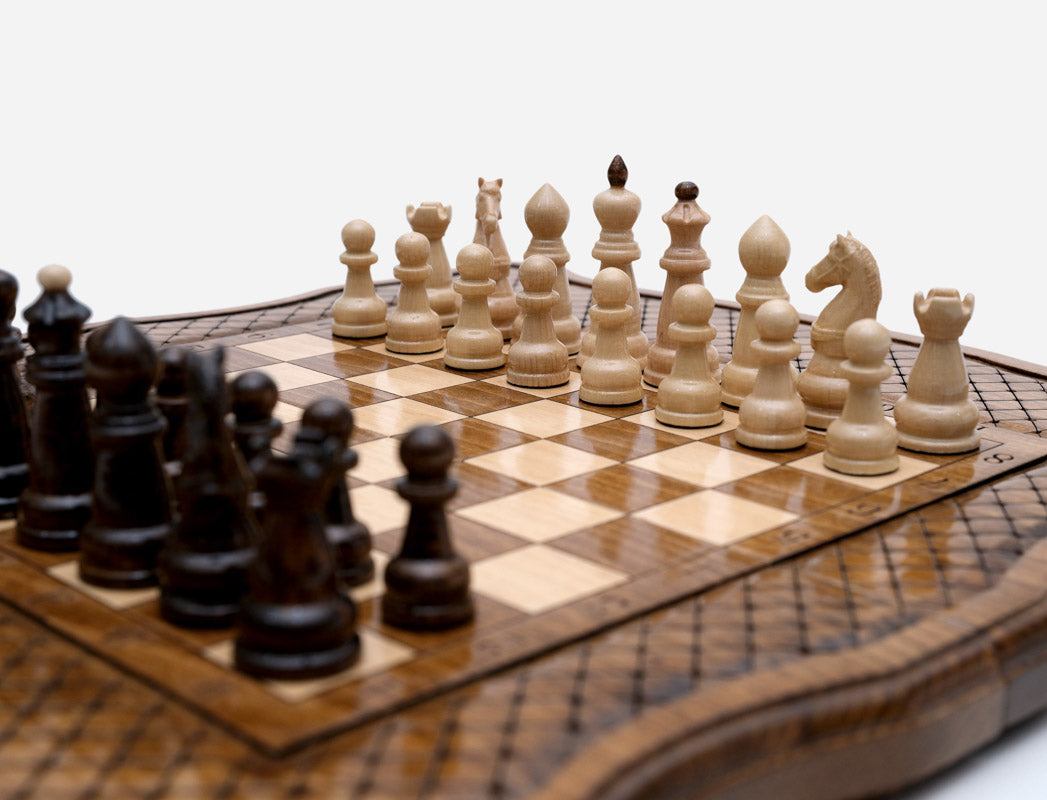 Close-up of Handle beech and walnut chess pieces set up on the board