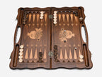 Angled view of the bronze pomegranate carved backgammon board