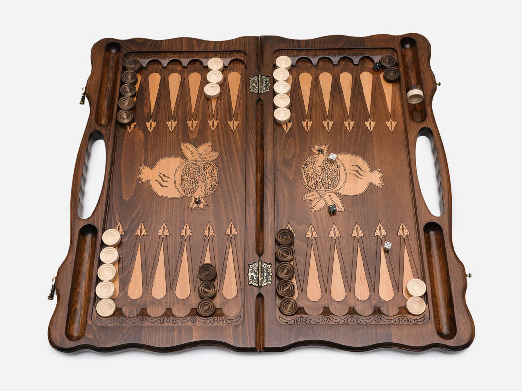 Angled view of the bronze pomegranate carved backgammon board