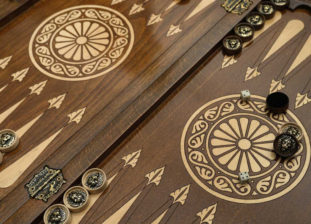 Close-up of the backgammon checkers, dice and cup on the Handle Lion table