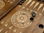 Close-up of the backgammon checkers, dice and cup on the Handle Tree of Life table