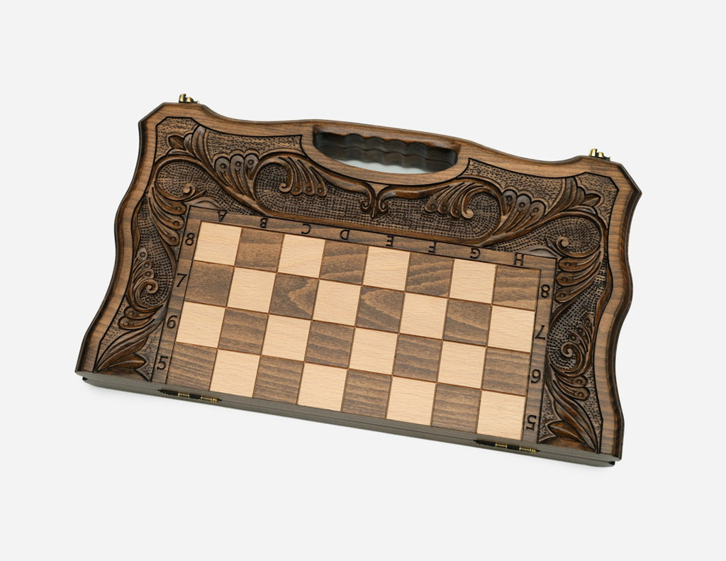 The folding chess board partly closed, showing its briefcase form and carved handle