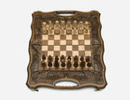 Angled view of the ornate folding chess set with beech and walnut Staunton pieces set up on the board