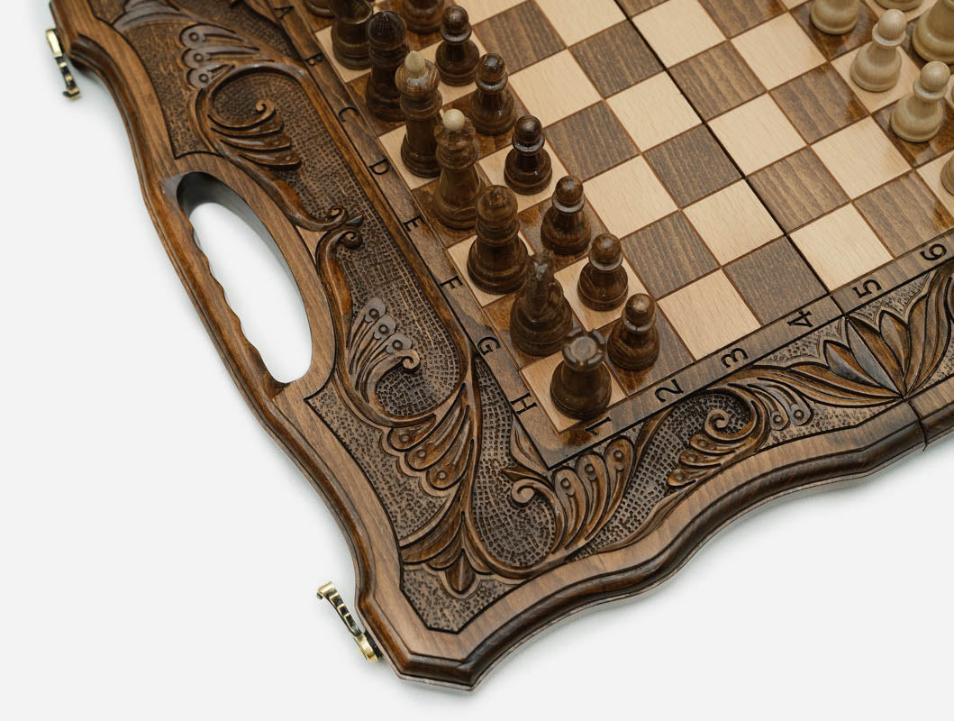 Close-up of the deep acanthus and scrollwork carving framing the chessboard