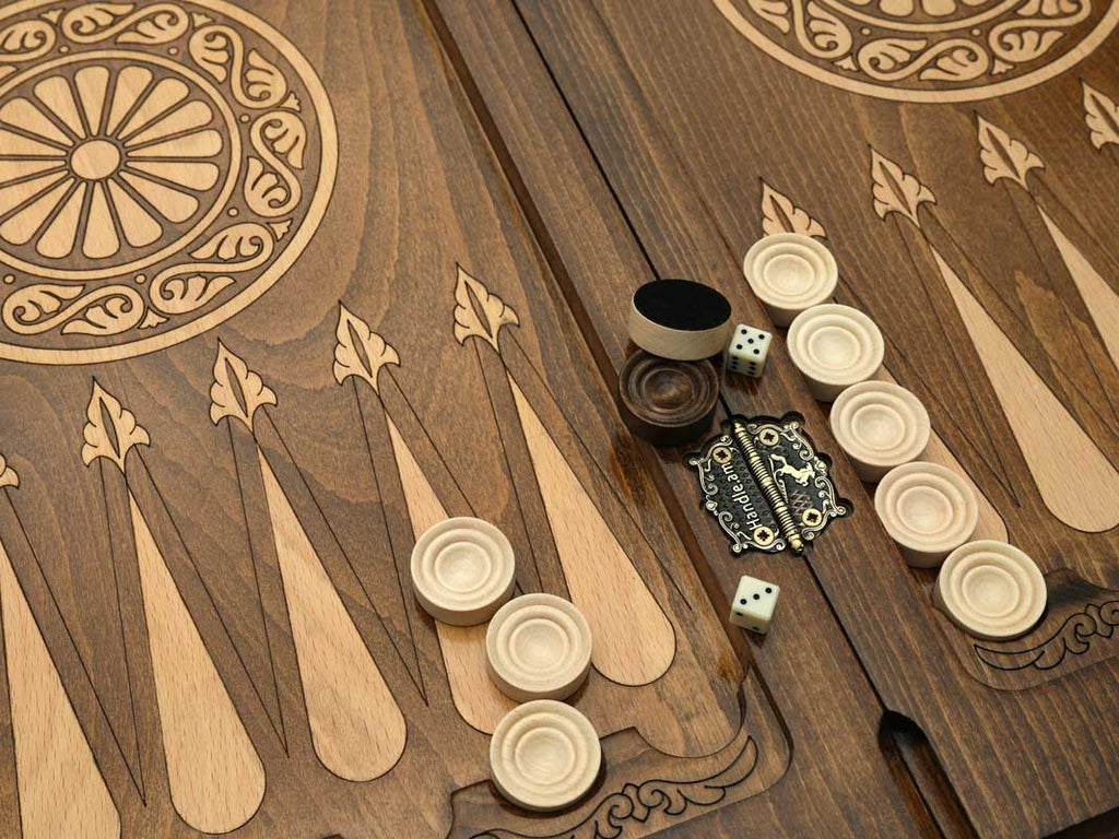 Close-up of the backgammon checkers, dice and cup on the Handle Eagle table