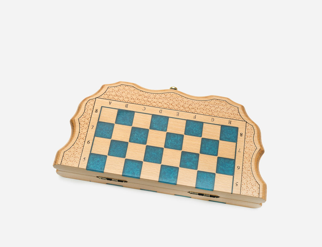 The compact blue epoxy chess set shown from an angle
