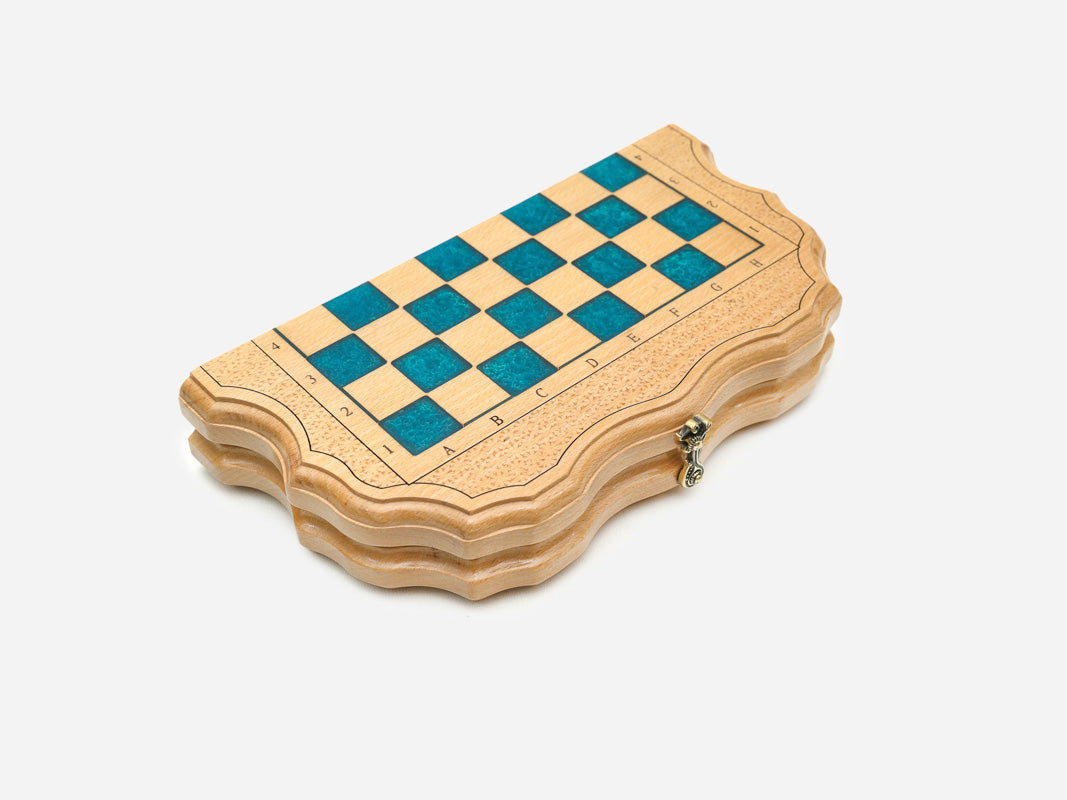 The folding board shown closed with its blue epoxy chessboard face