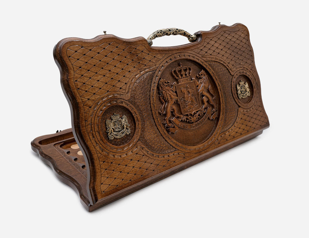 Carved beechwood backgammon board with the Georgian coat of arms in deep relief, bronze medallions and an ornate bronze handle, propped open