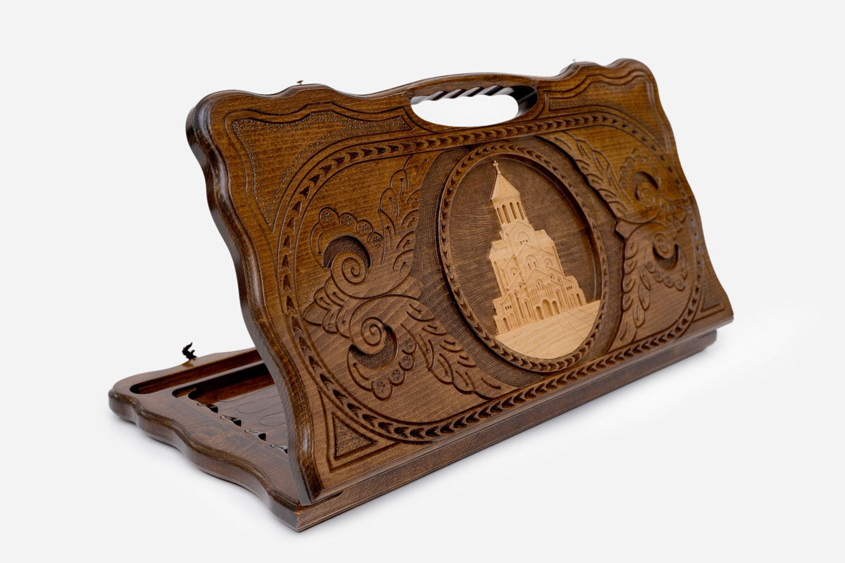 Carved beechwood backgammon board with the Holy Trinity Cathedral of Tbilisi in a medallion, with a carry handle, propped open