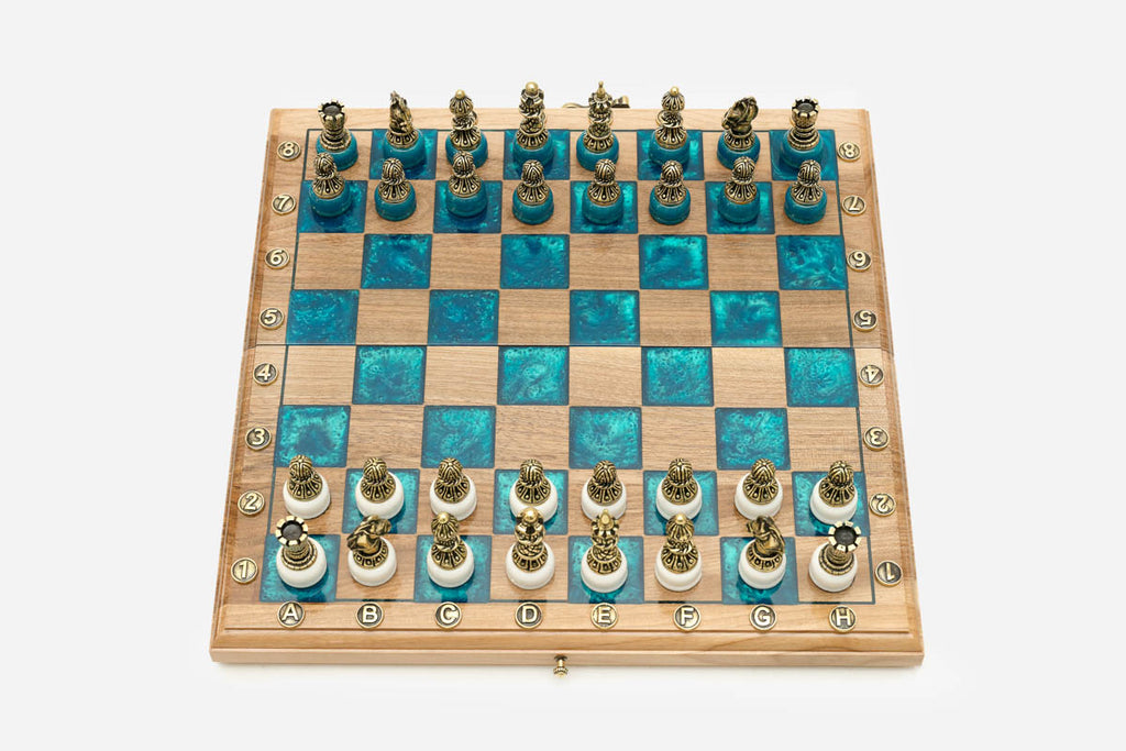 Angled view of the turquoise epoxy chess set with its bronze pieces