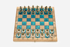 Angled view of the turquoise epoxy chess set with its bronze pieces
