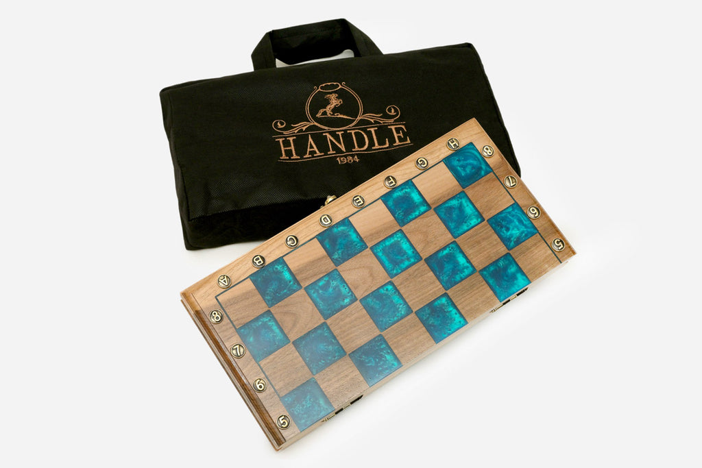 The turquoise epoxy chess set shown from an angle with its bronze army