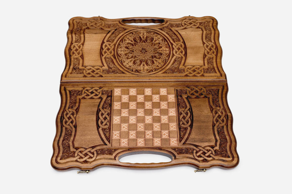 The backgammon board opened to show the wooden playing surface