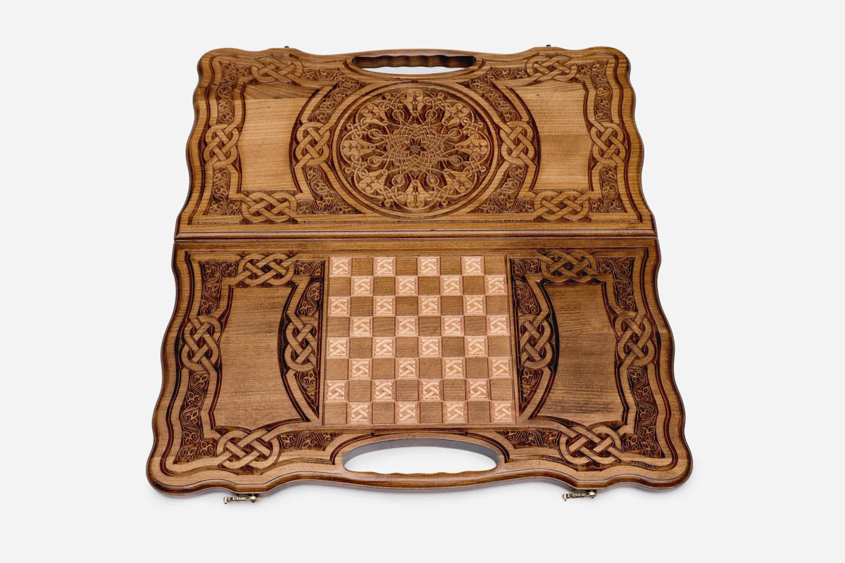 The backgammon board opened to show the wooden playing surface