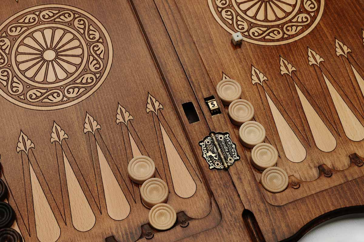 Angled view of the ornate rosette carved backgammon board