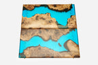Detail of the glossy turquoise epoxy surface and natural walnut grain