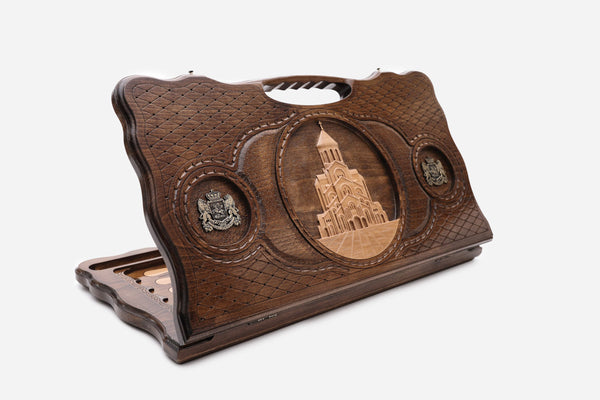 Carved beechwood backgammon board with the Sameba Cathedral of Tbilisi and bronze medallions, with a carry handle, propped open