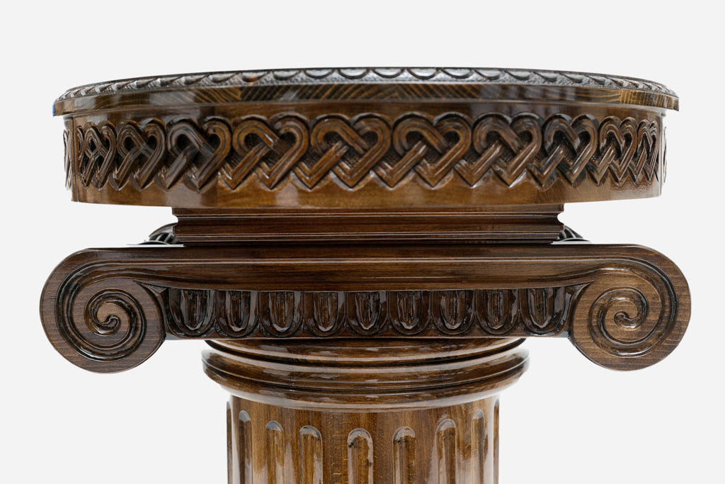 Detail of the hand-carved Ionic column capital supporting the round table top