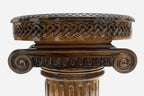 Detail of the hand-carved Ionic column capital supporting the round table top