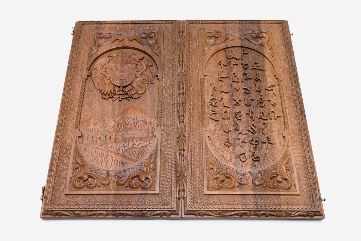 Detail of the alphabet relief and scrollwork border