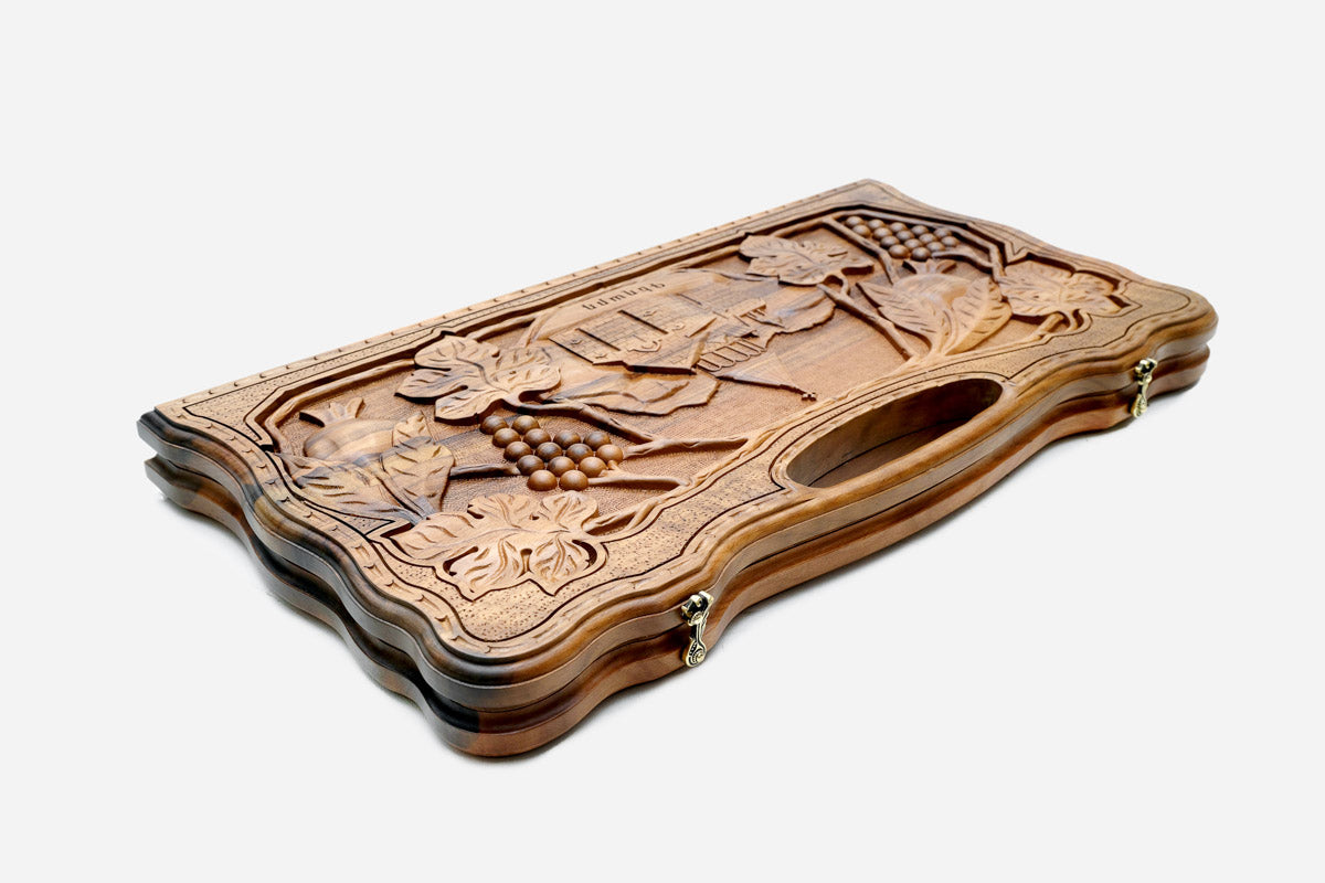The backgammon board opened to show the wooden playing surface