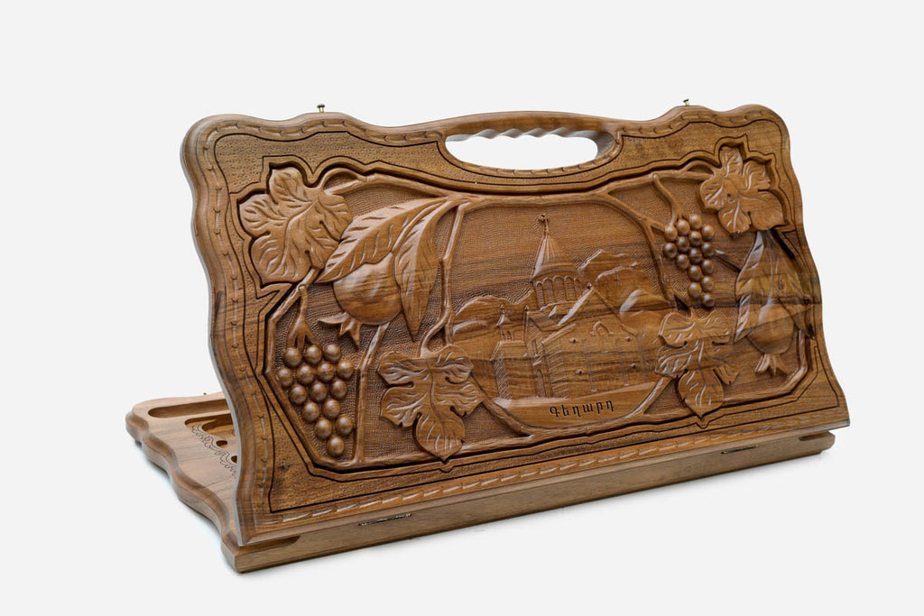 Carved walnut backgammon board with the Geghard Monastery and a carry handle, propped open