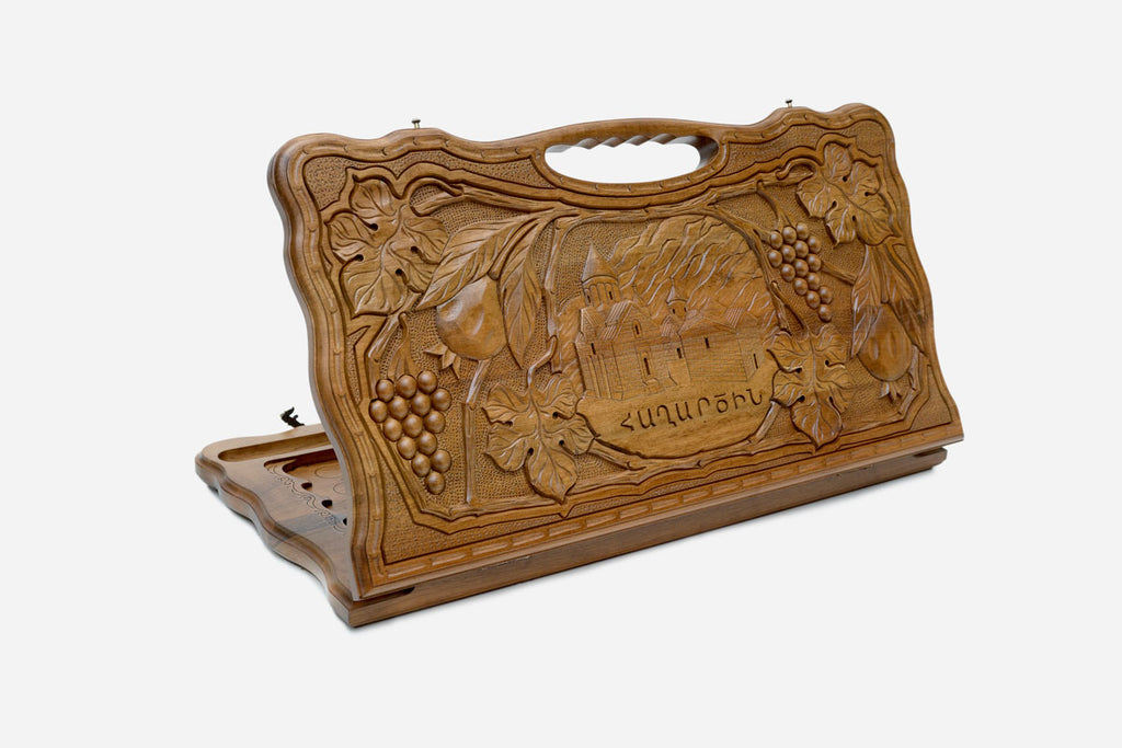 Carved walnut backgammon board with the Haghartsin Monastery and a carry handle, propped open