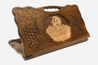 Carved beechwood backgammon board with the scene of Samson and the lion and a carry handle, shown propped open