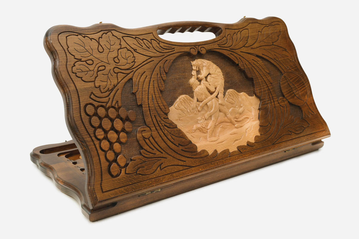 Carved beechwood backgammon board with the scene of Samson and the lion and a carry handle, shown propped open