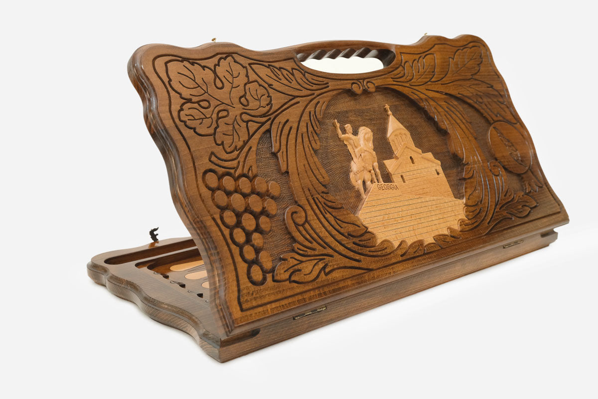 Carved beechwood backgammon board with King Vakhtang Gorgasali on horseback and a carry handle, shown propped open