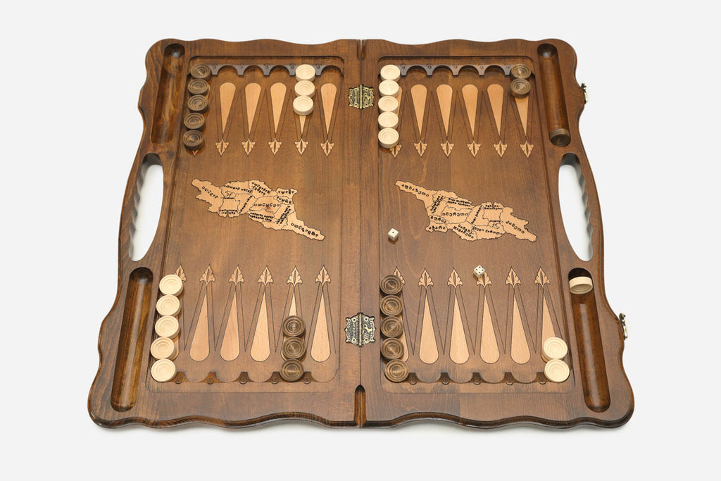 The backgammon board opened to show the wooden playing surface