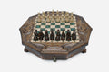 Octagonal carved wooden chess set with emerald-green epoxy squares and wooden Staunton pieces set up for play