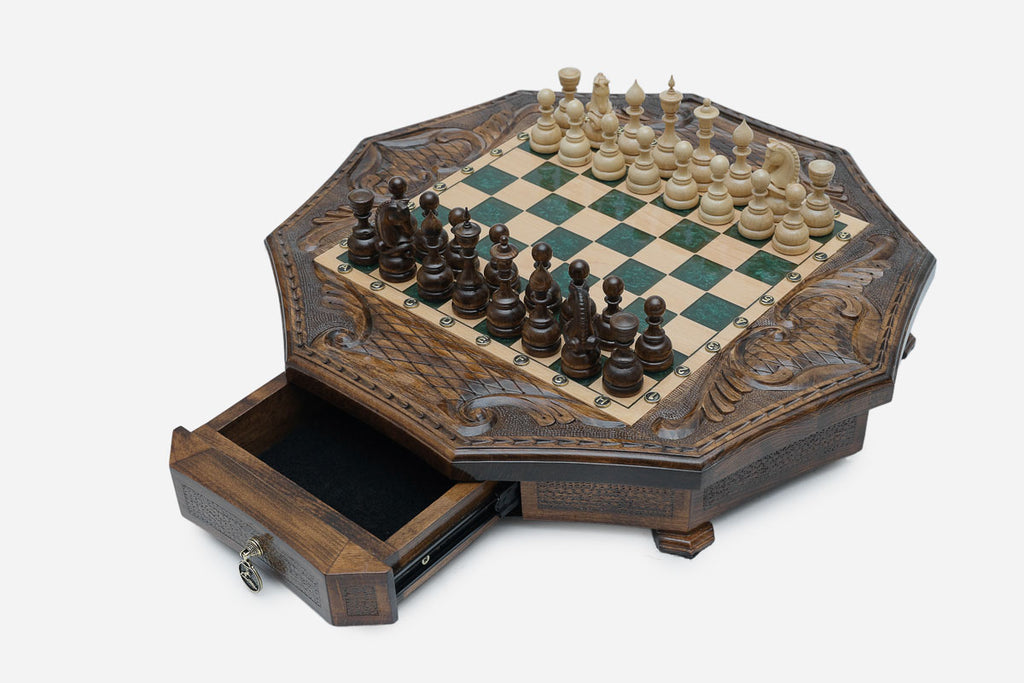 Angled view of the green epoxy board framed by carved eagle corner reliefs