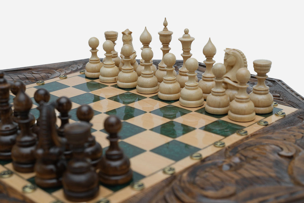 Close-up of the dark walnut chess pieces on the green epoxy board
