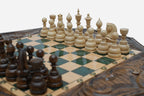 Close-up of the dark walnut chess pieces on the green epoxy board