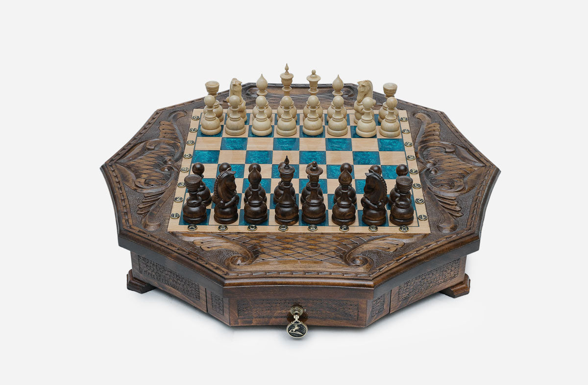 Octagonal carved wooden chess set with turquoise-blue epoxy squares and wooden Staunton pieces set up for play