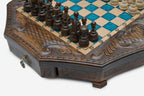 Close-up of the dark walnut chess pieces on the blue epoxy board