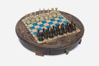 Full view of the round blue-epoxy chess board with light and dark wood pieces in starting position
