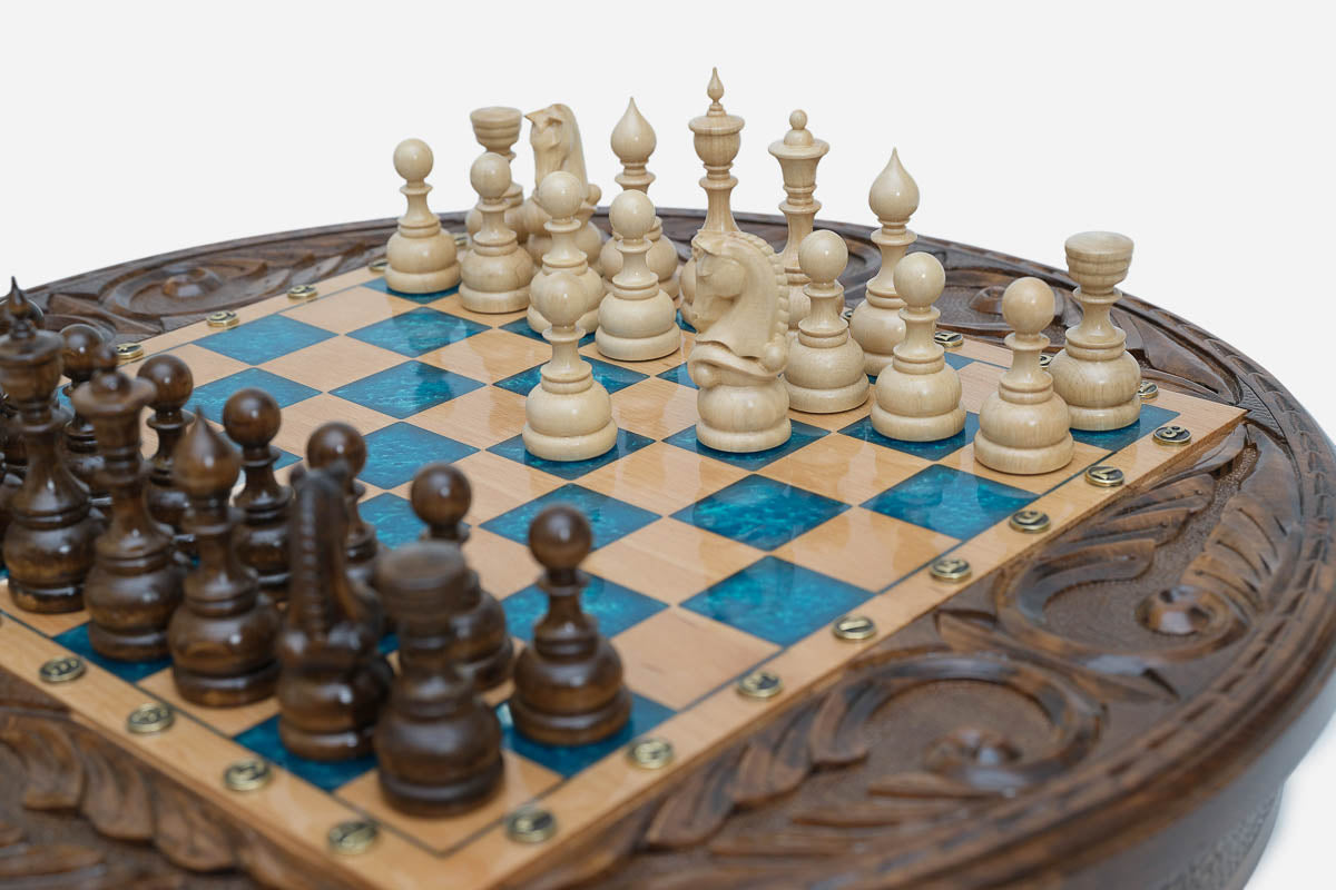 Detail of the carved acanthus-scroll frame surrounding the blue epoxy playing surface