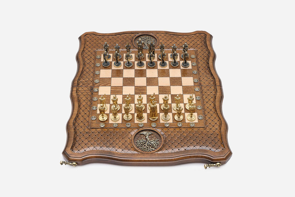 Top-down view of the Tree of Life chess set with gold and dark bronze figural soldier pieces arranged for play
