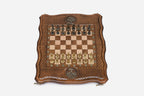 Overhead view of the wooden chess board with cast-metal medieval warrior pieces and bronze Tree of Life medallions