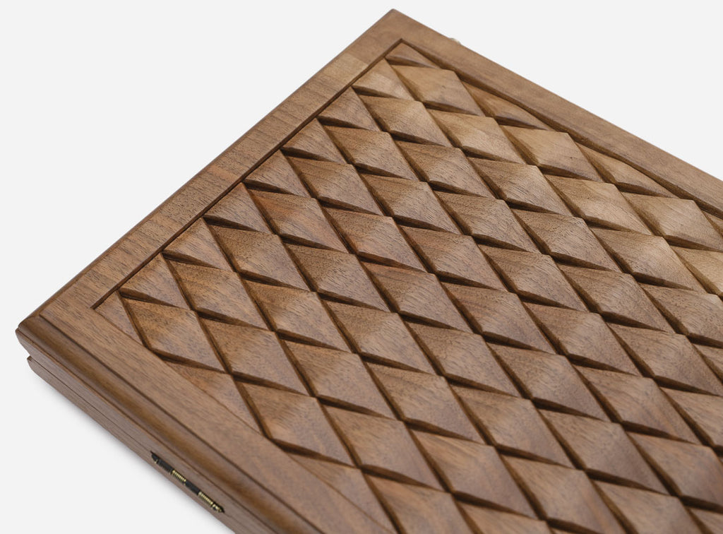 The backgammon board opened to show the wooden playing surface